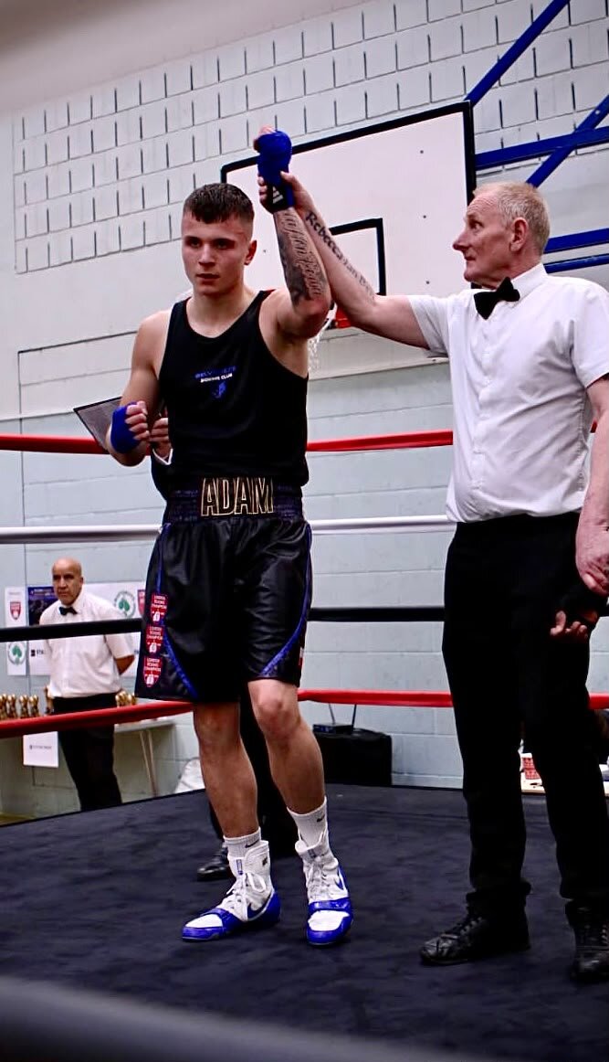Adam's hand raised after a win