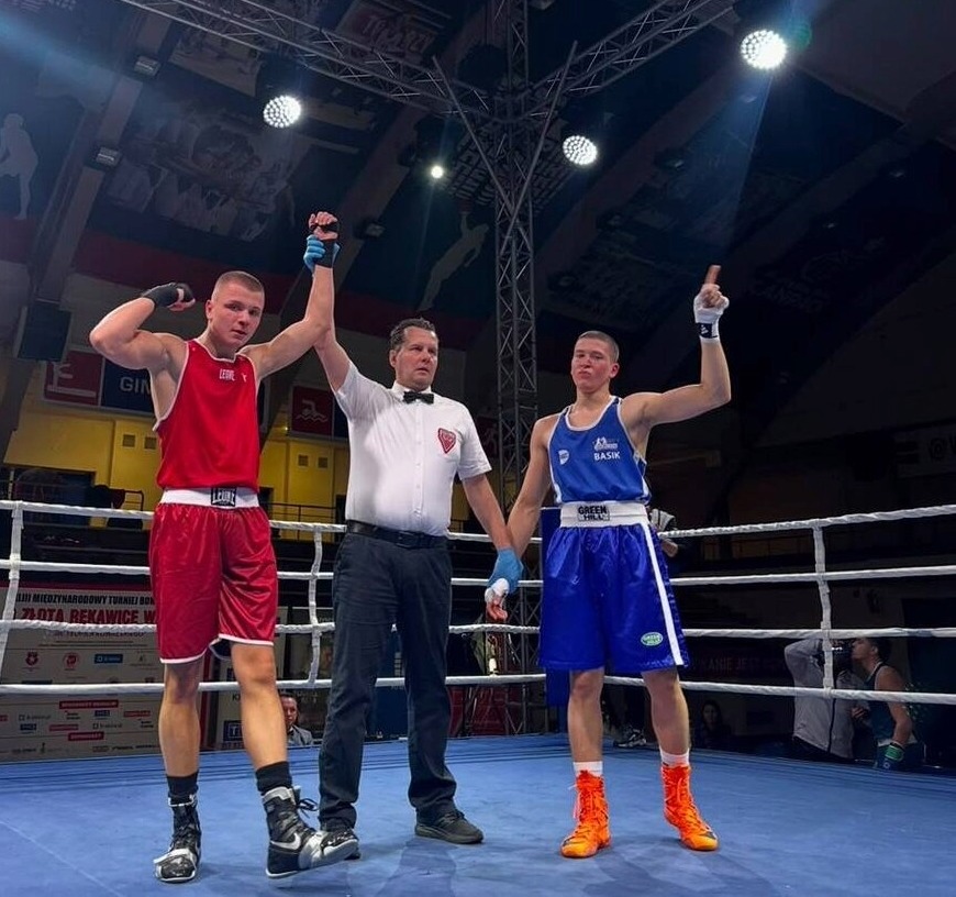 Adam's hand raised after an international bout